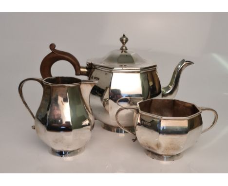 An Art Deco silver tea set, comprising teapot, sugar bowl and milk jug, hallmarked 1935/36, approx. weight 1305gms. IMPORTANT