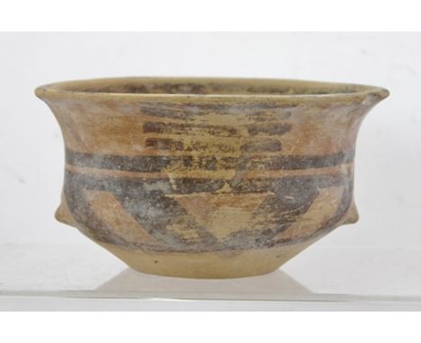 A PROBABLY NEOLITHIC DOUBLE HANDLED BOWL with scrolling decoration, approximately 15cm diameter 