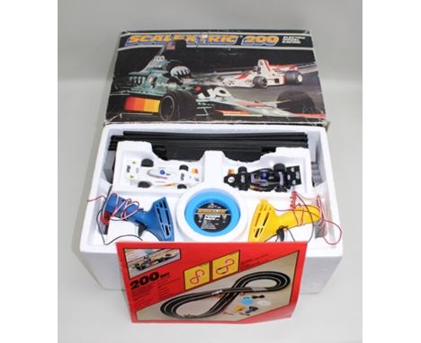 A SCALEXTRIC 200 ELECTRIC MODEL RACING KIT complete with two cars, controllers and track, instructions and in original vendor
