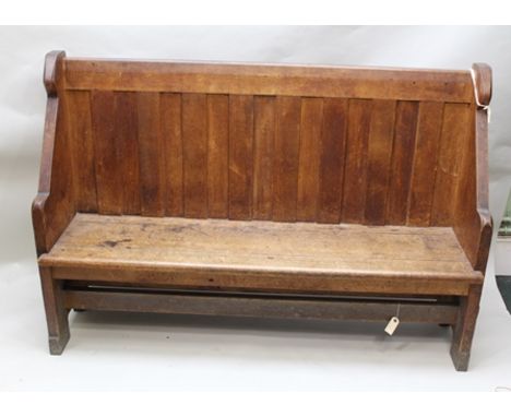 A 19TH CENTURY OAK LOW BACK SETTLE BENCH with shaped ends, 168cm wide 