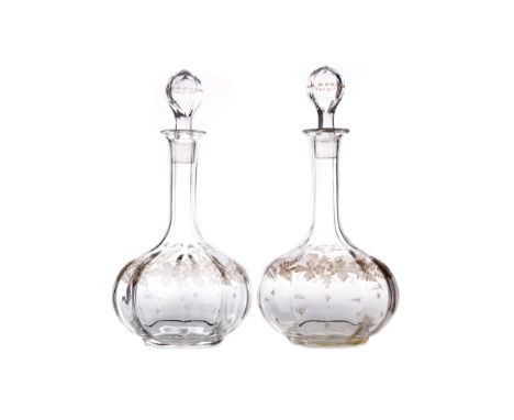 PAIR OF LATE VICTORIAN GLASS DECANTERS, of globe and shaft form, with stopper, the faceted neck above a body engraved with fe