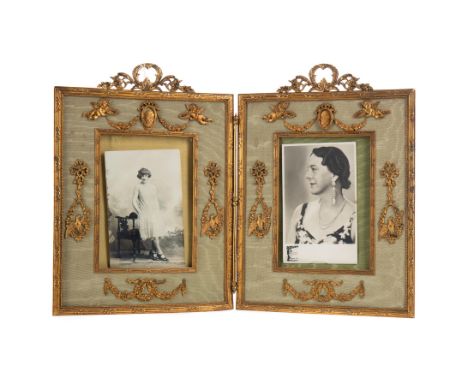 EARLY 20TH CENTURY ORMOLU DOUBLE PICTURE FRAME, with scroll and foliate surmount, the picture apertures with putti above and 
