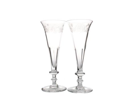 PAIR OF 20TH CENTURY CHAMPAGNE FLUTES BY WILLIAM YEOWARD, the faceted drawn trumpet bowls engraved with an upper band of scro