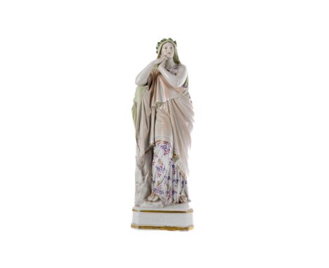 EARLY 20TH CENTURY GERMAN PORCELAIN FIGURE OF IPHIGENIA, modelled standing by a tree trunk with hands clasped, on a square ba