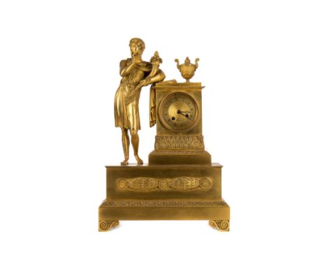 FRENCH EMPIRE ORMOLU MANTEL CLOCK, the circular dial contained within a 'Roman' plinth with outset urn, the timepiece with tw