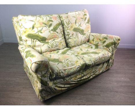 SMALL TWO SEAT SOFA, with scroll arms, detachable back and seat cushions, with floral printed loose covers Provenance: The Wi