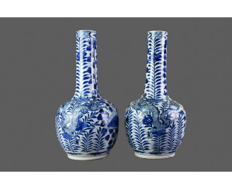 PAIR OF 19TH CENTURY CHINESE BLUE &amp; WHITE PORCELAIN VASES, of globe and shaft form, hand-painted with dragons set amongst