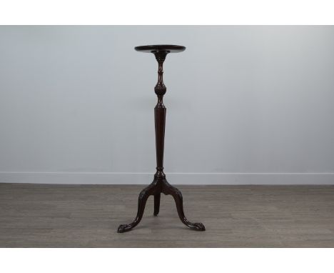 MAHOGANY TORCHERE OF ADAM DESIGN, the circular top on a tapered octagonal column, with carved leaf decoration to the tripod s
