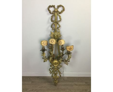 CAST BRASS WALL LIGHT OF 18TH CENTURY DESIGN, with ribbon cresting, with central sun burst, with four leaf cast candle sconce