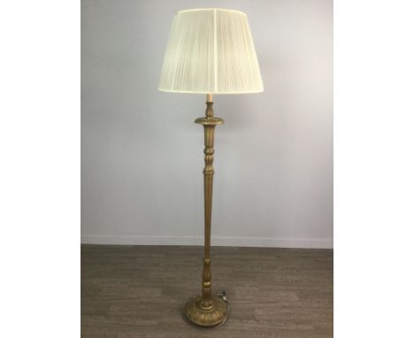 GILTWOOD FLOOR LAMP, with a tapering fluted column, on a circular base, with fabric shade, 185cm high overall Provenance: The