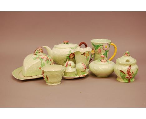 A collection of green Carltonware items, all with purple floral design, comprising butter dish, teapot, milk and sugar bowl, 