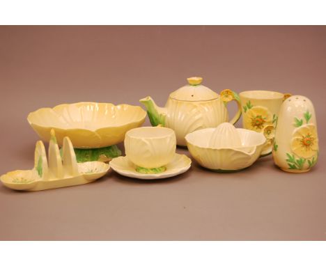 A collection of yellow Carltonware items, to include six cups and saucers, a teapot, a juicer, large bowl, toast rack and muc