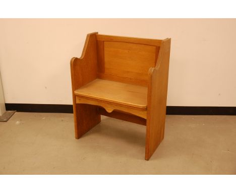 An early 20th century light oak single pew   