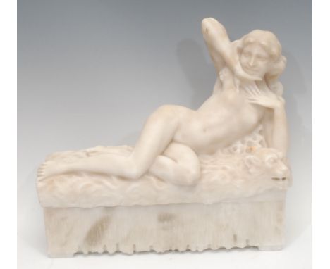 An Art Nouveau alabaster figural sculpture, of a reclining nude, she lies on a bed draped with a panther rug, 30cm high, 32cm