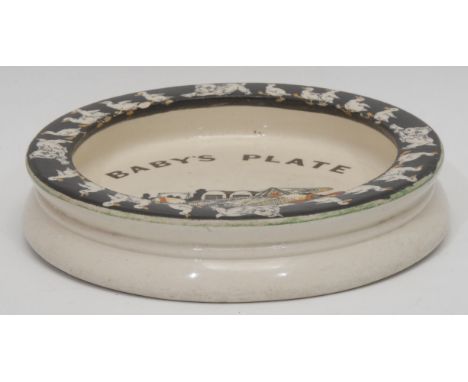 A Carlton Ware novelty baby’s plate, decorated with dogs, ducks and a monoplane