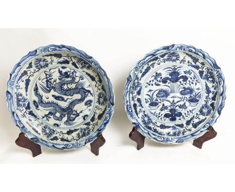 CHARGERS ON STANDS, a pair, Chinese export style blue and white ceramic, chargers 51cm diam., stand at 57cm H in stands. (2) 