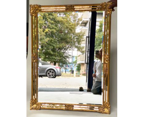 WALL MIRROR, Continental giltwood with bevelled plate, stepped marginal plates and foliate corners, 90cm W x 120cm H. 