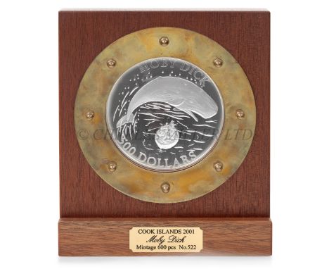 A COMMEMORATIVE $500 'MOBY DICK' COOK ISLANDS SILVER COIN, 2001the 4½in. coin mounted in wooden stand with porthole framing, 