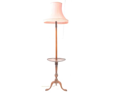 Early 20th century mahogany floor standing occasional table standing lamp. Shade to top with foliate carved detail panel abov