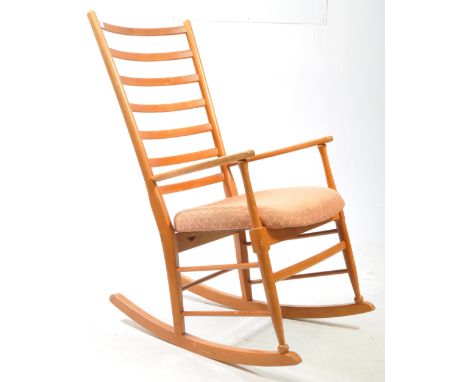 Danish Modern Design - Mid century teak rocking armchair. Ladder back with flat elbow rests on rocking legs with dual perimet