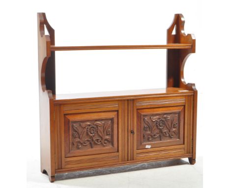 A Victorian 19th century Arts &amp; Crafts walnut hanging cabinet. Twin doors with fielded carved decoration, open shelf atop