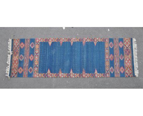 An early 20th century Islamic / Persian wall hanging Kelim floor rug - runner. Blue form with geometric patterns to the leadi