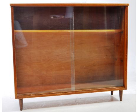 A vintage mid 20th century Herbert Gibbs manner teak bookcase cabinet. The cabinet featuring sliding glass door to front. Hav