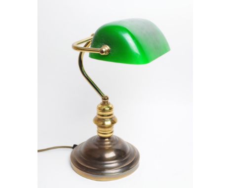 A vintage 20th Century bankers table top desk lamp light. Having green glass lightshade supported by brass arm raised on circ