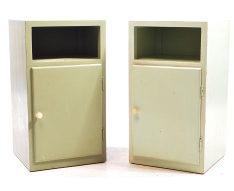 A pair of early 20th century painted bedside tables / pot cupboards. The pot cupboards raised on plinth bases with single cup