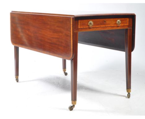 A Victorian 19th century mahogany and inlaid drop leaf dining table. The rectangular table crossbanded satinwood inlaid borde