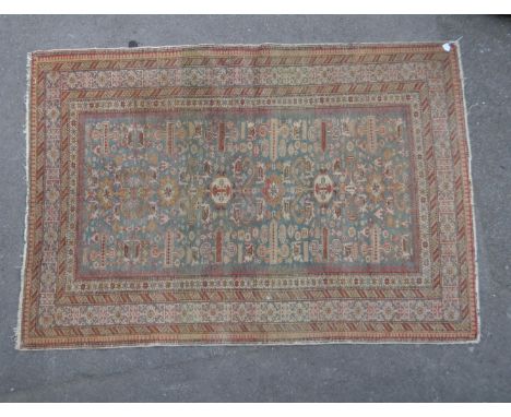 A vintage 20th century Persian carpet floor rug. The rug having a series of graduating borders each populated with geometric 