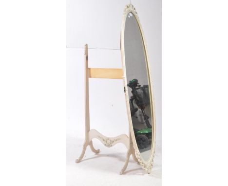 A vintage 20th century Louis XVI manner white painted cheval floor mirror. The mirror of oval form with floral decorated fram