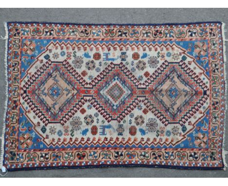 A vintage 20th century Persian Iranian Yalameh carpet floor rug. The rug featuring three connected geometric medallions to cr