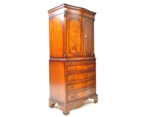 Queen Anne revival flame mahogany cocktail drinks cabinet. Raised on bracket feet with twin door mirror lined cabinet over fo