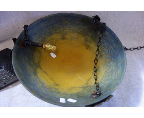 JEAN NOVERDY: A glass pendant ceiling light of circular dished form in mottled tones of blue and yellow mounted with three ca