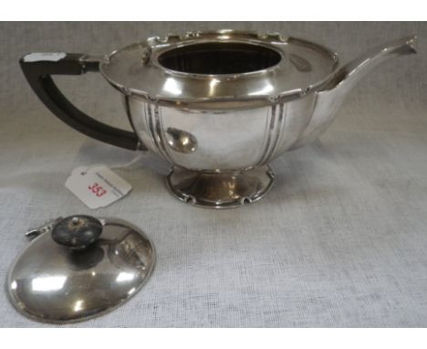 AN EDWARDIAN SILVER BATCHELOR'S TEAPOT, by William Hutton &amp; Sons, London, 1904, of circular form with wooden handle raise