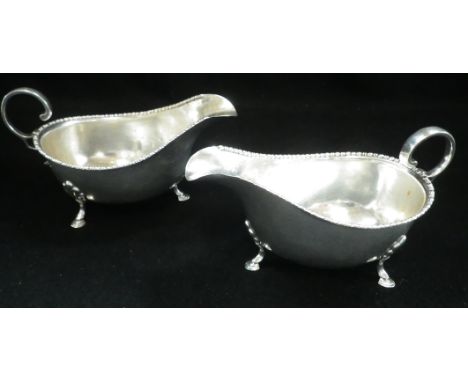 A PAIR OF SILVER SAUCE BOATS, by Harrison Bros &amp; Howson, Sheffield, 1927, of oval form with gadrooned border, scroll hand