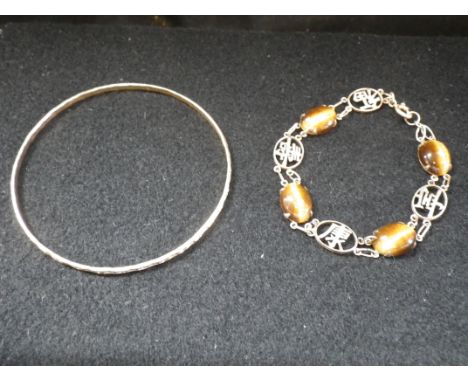 A 9K YELLOW GOLD CHINESE BRACELET set with hard stones, together with an unmarked yellow metal bangle (2)