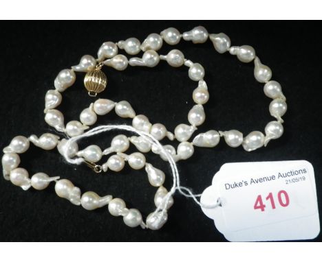 A CULTURED PEARL NECKLACE with a gold clasp