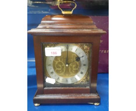 ASPREY &amp; GARRARD; A MAHOGANY CASED MANTEL CLOCK with brass face and silver chapter ring, with original box