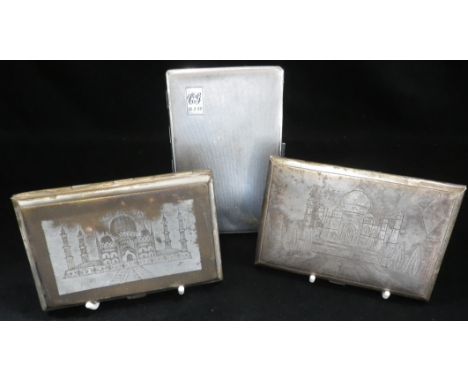 AN INDIAN WHITE METAL SILVER CIGARETTE CASE engraved with a scene of the Taj Mahal, together with another and a chrome plated