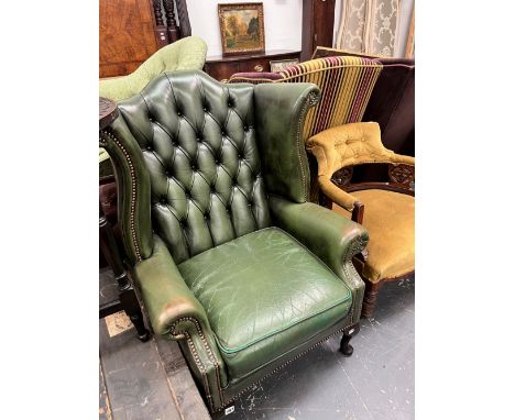 A GREEN LEATHER BUTTON BACK GEORGIAN STYLE WING CHAIR