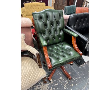 A GREEN LEATHER BUTTON BACK SWIVEL OFFICE ARMCHAIR