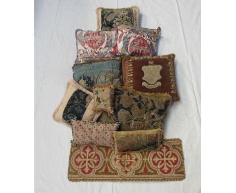 Ten country house style tapestry cushions, one with armorial crest, a pair of cushions depicting hot air balloons with Orient