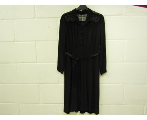 A 1940's silk crepe dress, the yoke has open lacework detail, with a popper front fastening with a faux button front.  The dr