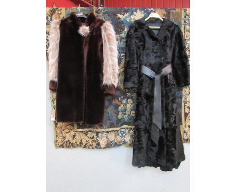A black Persian lamb ladies 3/4 length coat, the coat has a slight outswept look bearing a black leather self tie belt and tw
