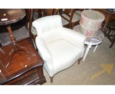 An Edwardian button back tub shaped easy chair