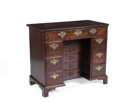 A George III mahogany kneehole desk, the rectangular top with moulded re-entrant corners above a single long drawer over the 