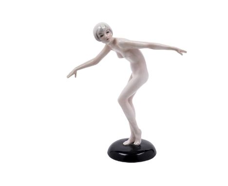 Lorenzl for Goldscheider: a Goldscheider Art Deco earthenware figure of a nude dancer, circa 1926, with arms outstretched on 