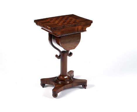 An Edwardian Regency style rosewood work and games table, the rectangular hinged top inset with a satinwood chess board, open